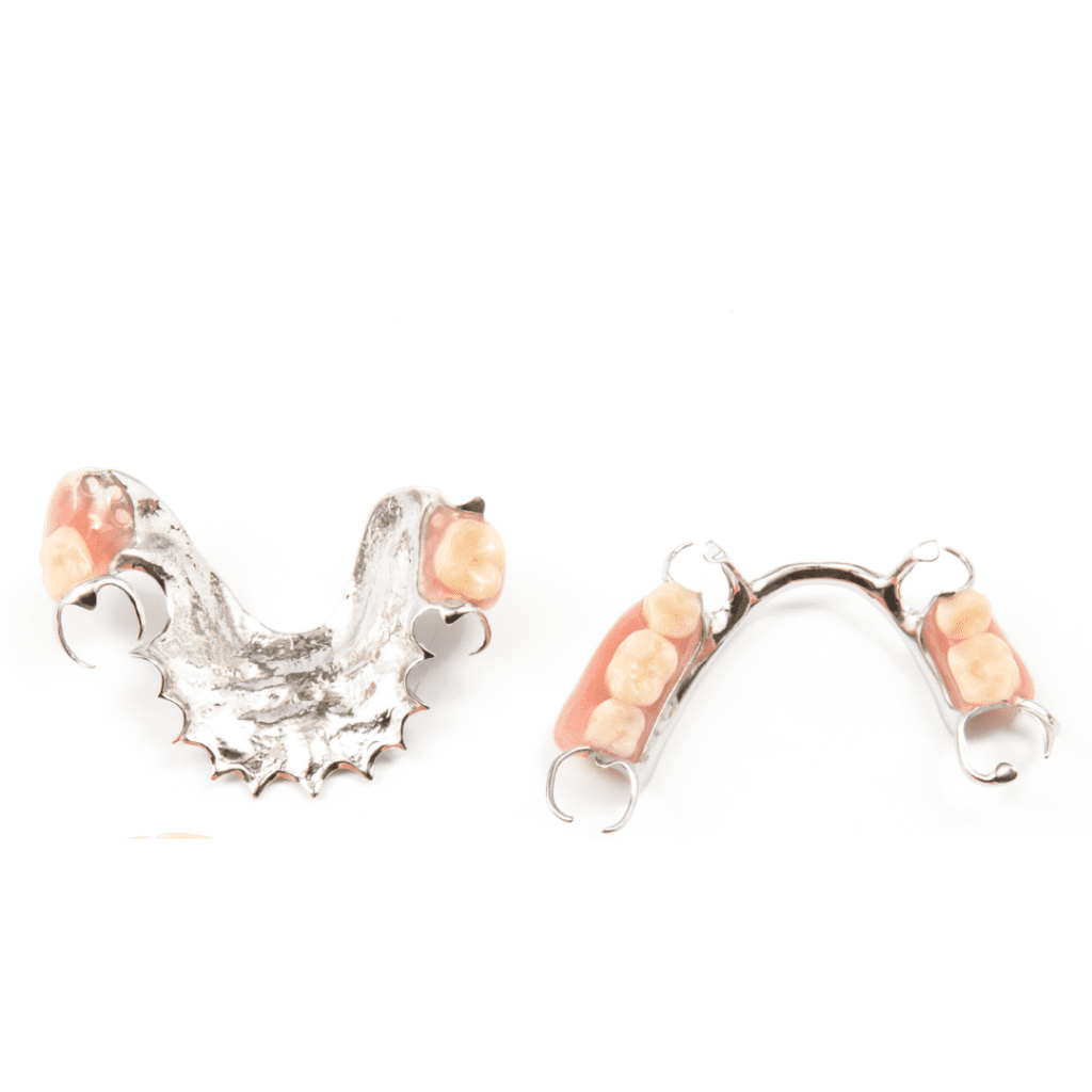 Custom-fitted partial dentures with metal clasps and acrylic teeth from The Denture Company in Nampa, Idaho, displayed on a white background.