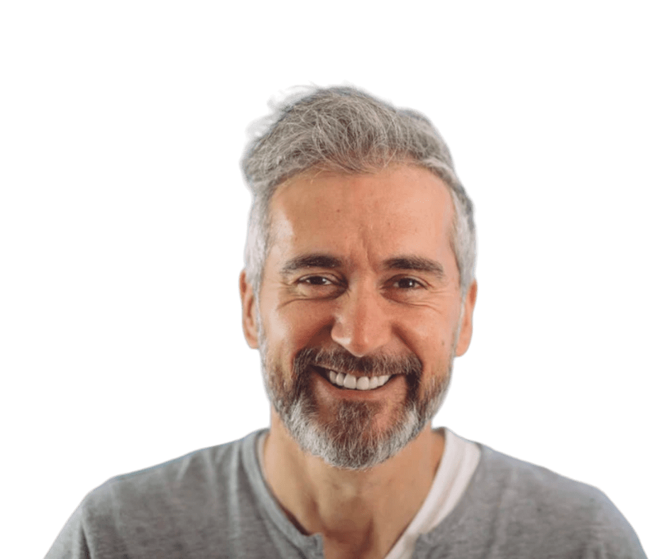 A smiling man with grey hair, possibly after receiving affordable dentures or wisdom teeth extractions.
